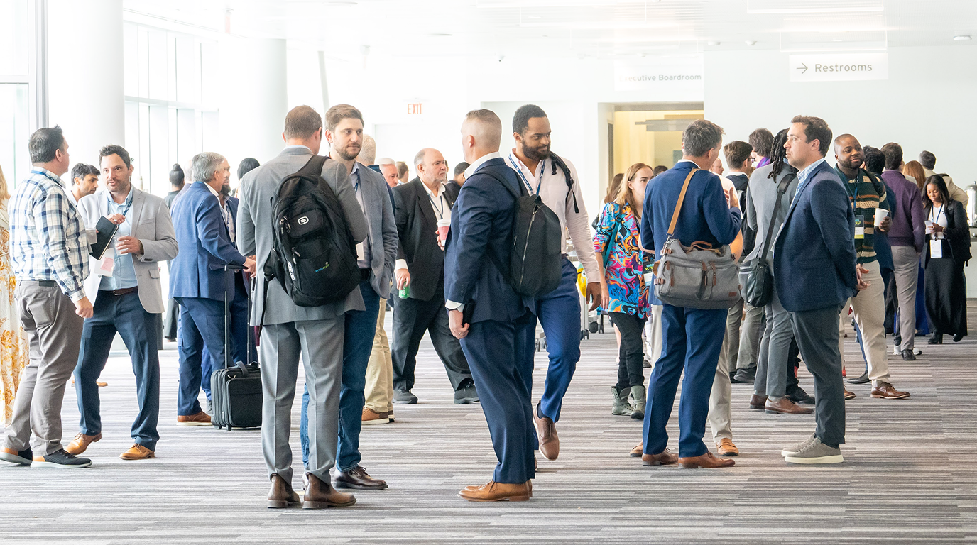 Event attendees gathered in a bright convention space.